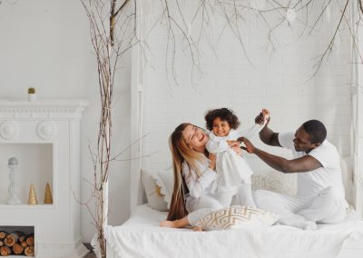 Happy interracial couple with their little daughter at home